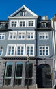 low angle view of beautiful traditional gray house with white windows at sunny