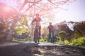 Low angle view of biker couple cycling on countryside road Royalty Free Stock Photo