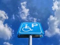 Low Angle View of Blue Handicapped Parking Sign Against Blue Cloudy Sky Royalty Free Stock Photo