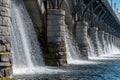 Powerful Water Flow Through Historic Stone Bridge Dam Royalty Free Stock Photo