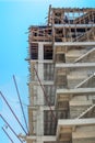 Low angle view of a building under construction with unfinished concrete staircases and construction site safety net