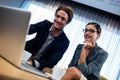 Low angle view of business associate looking a laptop