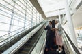 Business people with bags discussing over digital tablet on escalator in a modern office Royalty Free Stock Photo