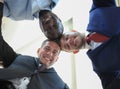 Low angle view of business people with their heads together. Royalty Free Stock Photo