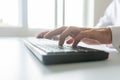 Low angle view of business programmer using computer keyboard