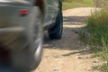 Low Angle View Of A Car Driving On A Country Road On A Sunny Summer Day. Motion Blur Effect. Royalty Free Stock Photo