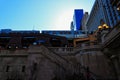 Low angle view of Chicago elevated `el` train over Wells Street with stairs leading down to riverwalk.