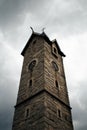 Low angle view of church tower against cloudy sky.