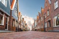 low angle view of cobbled street and typical buildings in dutch town of Volendam Royalty Free Stock Photo