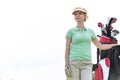 Low angle view of confident female golfer standing against clear sky Royalty Free Stock Photo