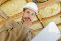 Low angle view contemplative builder holding clipboard Royalty Free Stock Photo