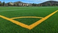 Low angle view from corner arc down sideline of combination American football and soccer field. Royalty Free Stock Photo