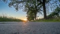 Low angle view of a country road under a dramatic colorful sunset sky. Beautiful Evening Sky Above Rural Landscape With Royalty Free Stock Photo