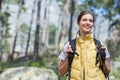 Female hiker exploring mountain forest trail wearing yellow vest and backpack with pad, copy space Royalty Free Stock Photo
