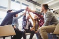 Low angle view of creative business people giving high-five Royalty Free Stock Photo