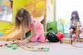 Cute girl building a structure in balance during playtime at the kindergarten Royalty Free Stock Photo