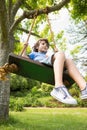 Low angle view of a cute little boy on swing Royalty Free Stock Photo