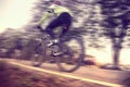 Low angle view of cyclist riding mountain bike, Vintage style Royalty Free Stock Photo