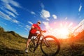 Low angle view of cyclist standing with mountain bike on trail at sunset Royalty Free Stock Photo