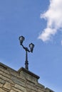 A low angle view of a lamp post on a stone bridge. Royalty Free Stock Photo