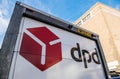 Low angle view of DPD parcel delivery van back in front of brick building Royalty Free Stock Photo
