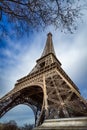 Low angle view Eiffel Tower and passing clouds, Paris, France Royalty Free Stock Photo