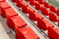 Low angle view of elecric orange sport facility spectator seats in renovated sport venue.