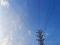 Low angle view of electrical pylon against the blue sky. Royalty Free Stock Photo