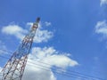 Low angle view of electricity pylon against blue sky Royalty Free Stock Photo