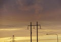 Low angle view of electricity pylons against sky during sunset Royalty Free Stock Photo