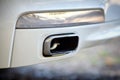 Low angle view of the exhaust pipe of a car with selective focus on tailpipe