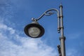 view of a fancy lamp post against a cloudy sky on a sunny day Royalty Free Stock Photo
