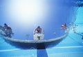 Low angle view of female swimmers ready to dive in pool from starting position