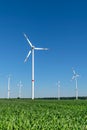 Low angle view of five wind power turbines, part of a wind farm, on a green field in eastern Germany near the city of Cottbus.