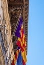 Low angle view of flags on beautiful historic building against clear blue sky