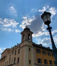 View form The Pons Fabricius of sun shining behind clouds at sunset over Tiber Island in Rome, Italy