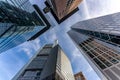 low angle view of four skyscrapers with different facade designs under the blue sky