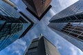 low angle view of four skyscrapers with different facade designs under the blue sky