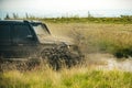 Low angle view of front of SUV on mountain road. Off-road Jeep car on bad gravel road. Mud and water splash in off-road Royalty Free Stock Photo