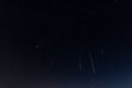 Low-angle view of the Geminids meteor shower in the dark night sky