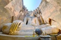 Low angle view of a giant ancient Buddha statue in Temple Wat Si Chum in Sukhothai Historical Park, Thailand Royalty Free Stock Photo