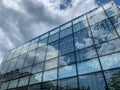 Low angle view of glass facade reflecting the sky Royalty Free Stock Photo