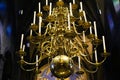 Low angle view on golden chandelier with candles under dome of romanesque catholic church Basiliek van Onze-Lieve-Vrouw-Tenhemelo