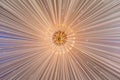 Low-angle view of a golden chandelier handing from the beige tent ceiling - a glamourous background