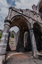 Stone Arches and Columns of Gothic Abbey Ruins Against Blue Sky Royalty Free Stock Photo