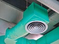 Low Angle View of Green Insulated Air Conditioning Duct with Round Grille Diffuser