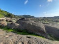 Low angle view from grey ball shaped rock stones at a rocky sand beach Royalty Free Stock Photo