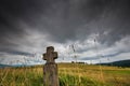 Low angle view of a hand carved old stone cross , dramatic stormclouds Royalty Free Stock Photo