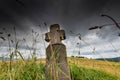 Low angle view of a hand carved old stone cross , dramatic stormclouds Royalty Free Stock Photo