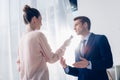 Low angle view of handsome businessman giving interview to journalist with voice recorder Royalty Free Stock Photo